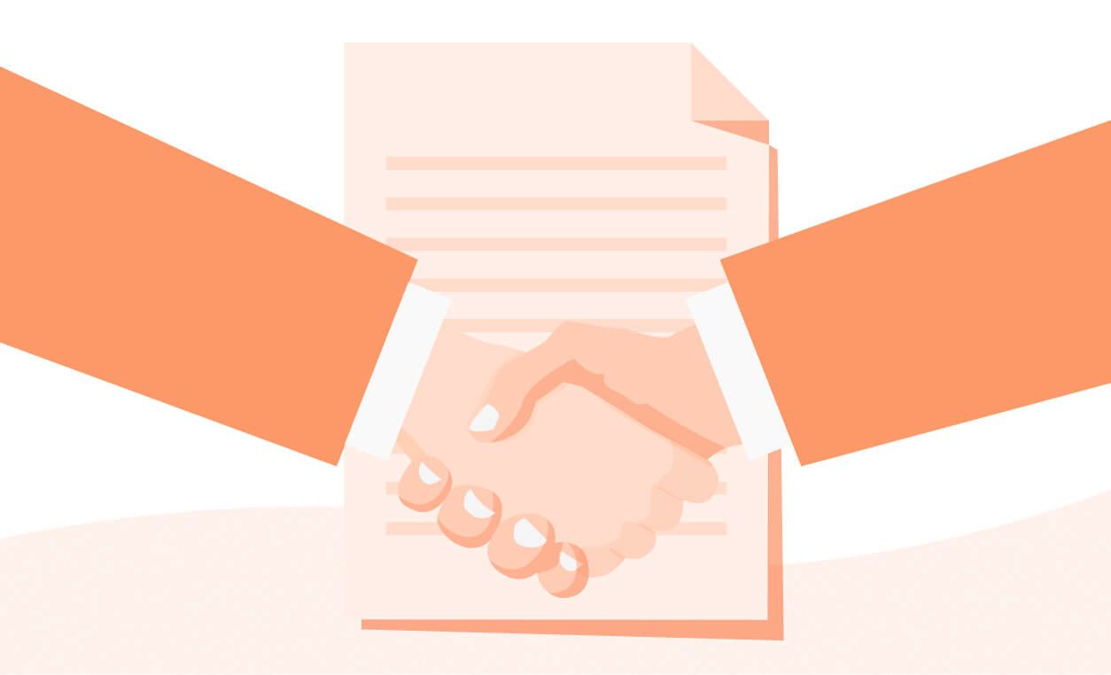 Two hands shake over a document, symbolizing agreement or contract completion.